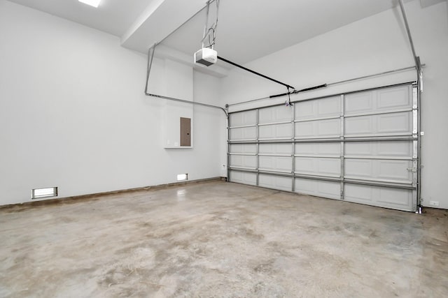 garage featuring a garage door opener and electric panel