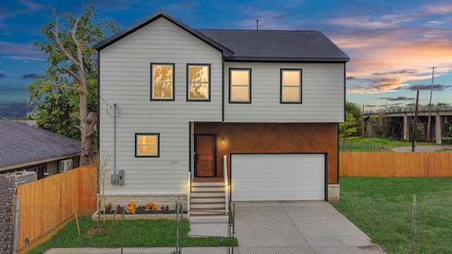 view of front of home featuring a garage and a yard