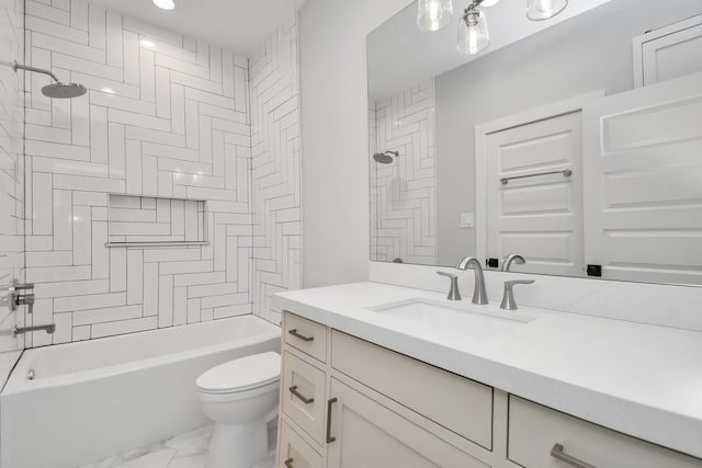 full bathroom featuring tiled shower / bath, vanity, and toilet