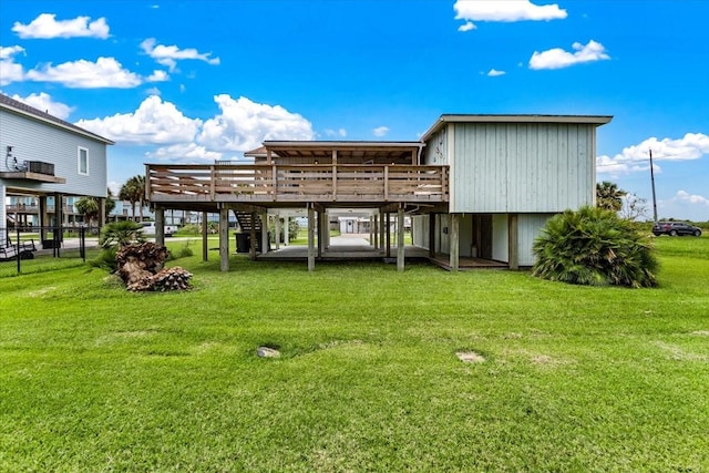 rear view of house with a deck and a yard