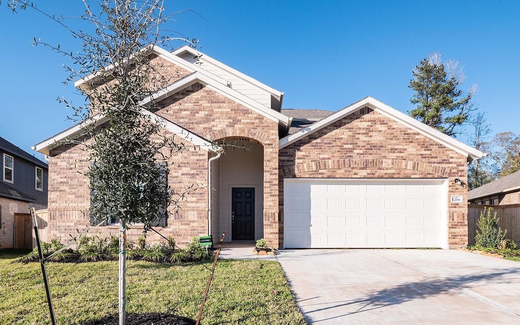 view of front property featuring a garage and a front lawn