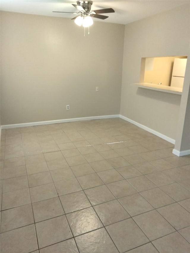 spare room with light tile patterned floors and ceiling fan