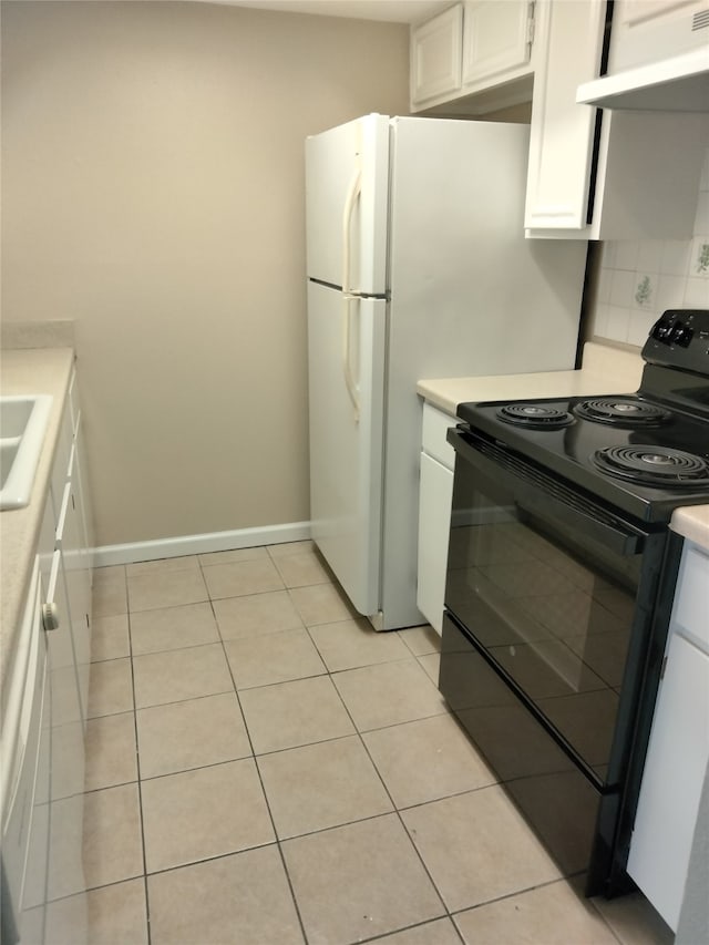 kitchen featuring black electric range oven, decorative backsplash, white cabinetry, light tile patterned flooring, and ventilation hood