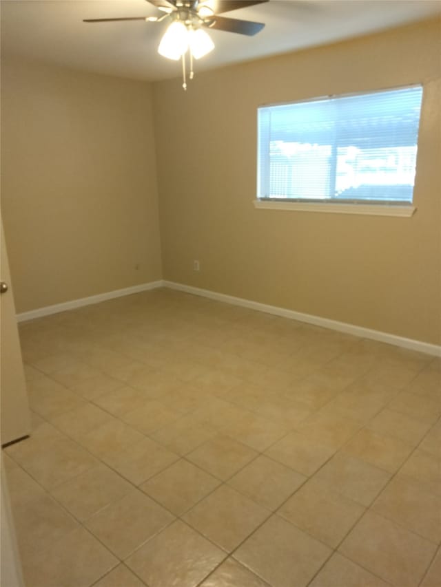 empty room featuring ceiling fan and light tile patterned flooring