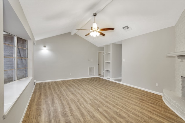 unfurnished living room with ceiling fan, light hardwood / wood-style floors, a brick fireplace, brick wall, and lofted ceiling with beams