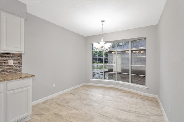 unfurnished dining area featuring a notable chandelier and light tile patterned floors