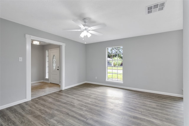 empty room featuring ceiling fan and hardwood / wood-style floors