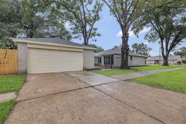 ranch-style house with a garage and a front yard