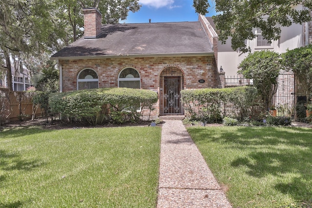 english style home with a front lawn