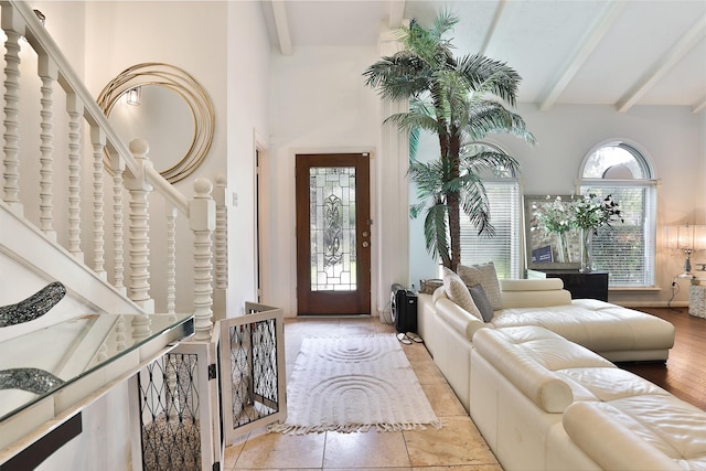 entryway with beam ceiling and light hardwood / wood-style floors