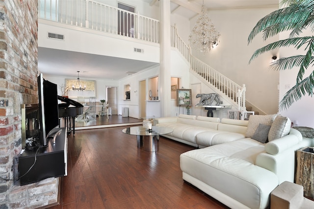 living room featuring dark hardwood / wood-style flooring, high vaulted ceiling, beamed ceiling, and an inviting chandelier