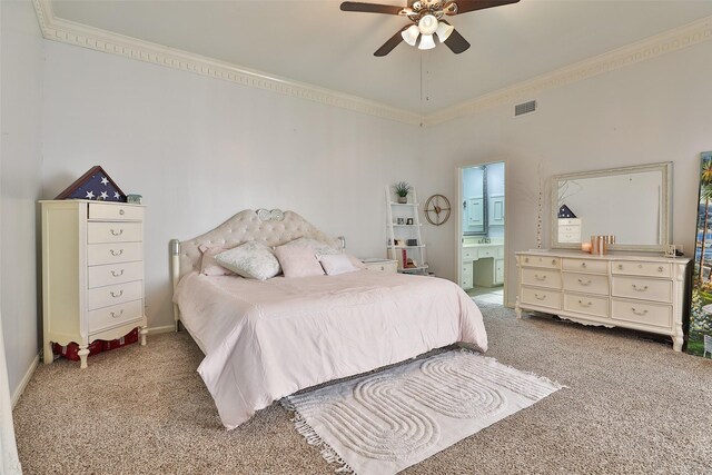 bedroom with carpet flooring, ceiling fan, ornamental molding, and connected bathroom