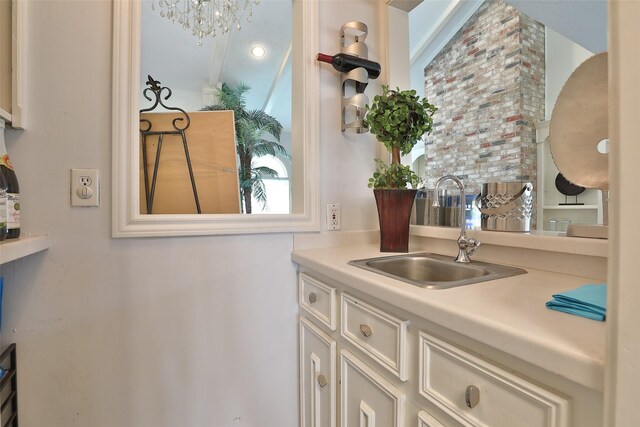 kitchen with sink and a chandelier