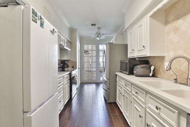 kitchen with sink, white cabinetry, stainless steel appliances, and dark wood-type flooring