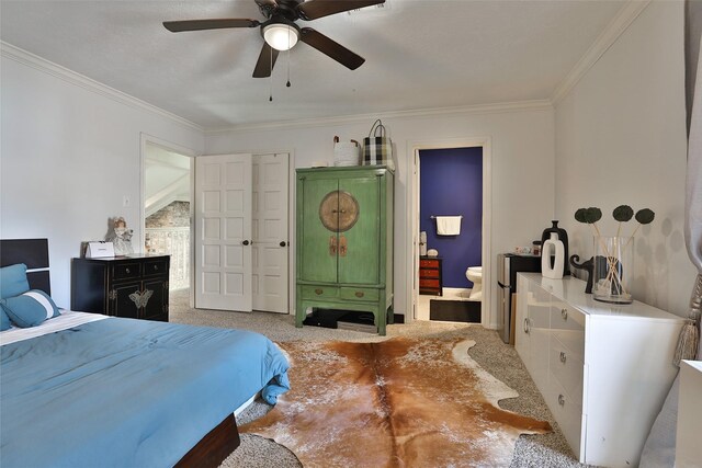 bedroom with ensuite bath, ceiling fan, light colored carpet, and ornamental molding