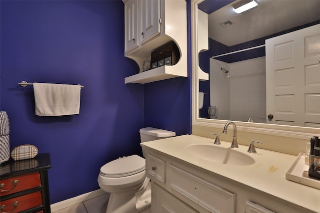 bathroom featuring tile patterned flooring, vanity, toilet, and a shower