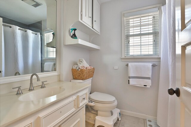 bathroom featuring tile patterned flooring, vanity, and toilet