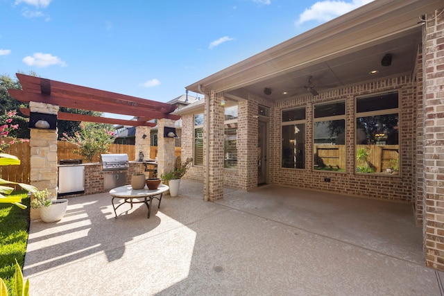 view of patio / terrace with a grill, a pergola, ceiling fan, and exterior kitchen