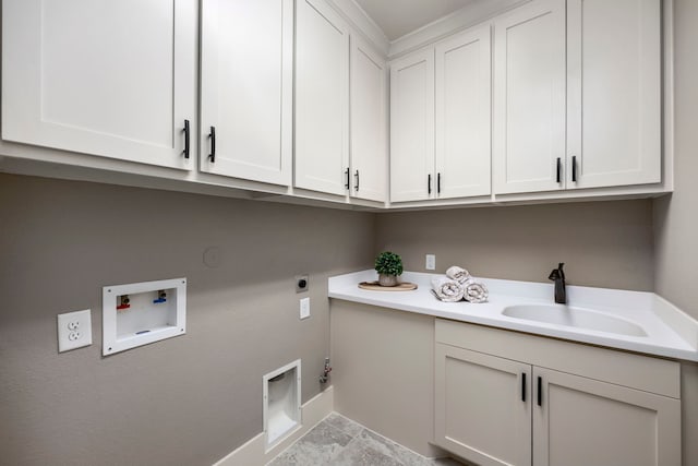 laundry area featuring sink, gas dryer hookup, cabinets, electric dryer hookup, and washer hookup