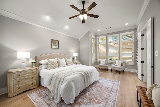 bedroom featuring ornamental molding, lofted ceiling, light wood-type flooring, and ceiling fan