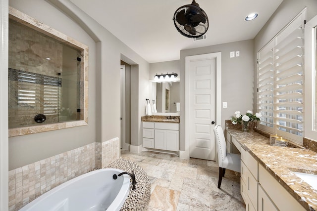 bathroom with vanity and independent shower and bath