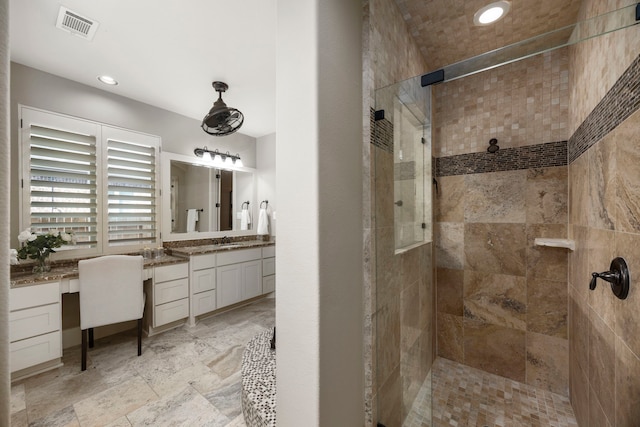 bathroom featuring vanity and a tile shower