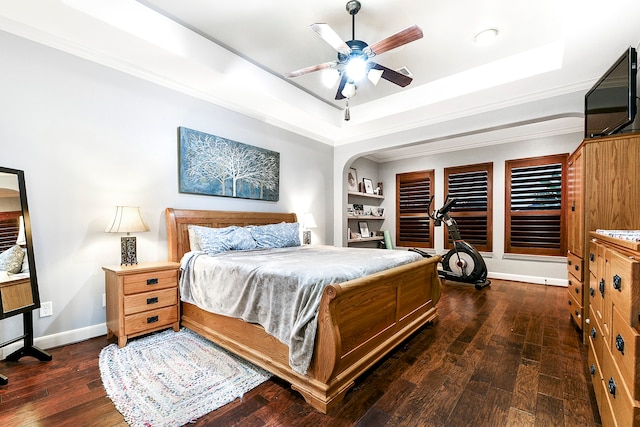 bedroom featuring a tray ceiling, dark wood-type flooring, and ceiling fan