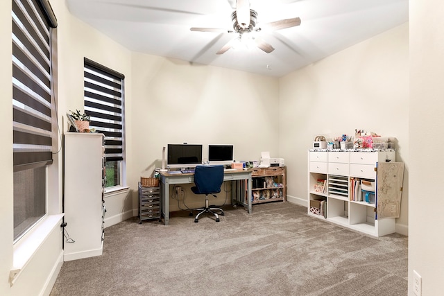 office space with light colored carpet and ceiling fan