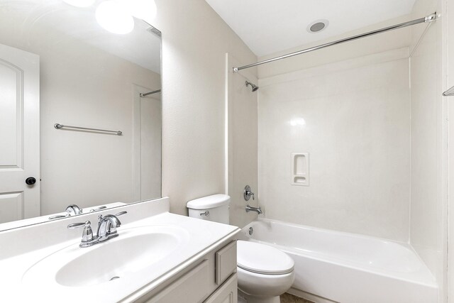 full bathroom featuring bathing tub / shower combination, toilet, and vanity