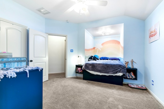 carpeted bedroom with ceiling fan and vaulted ceiling