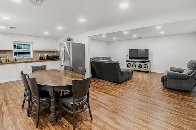 dining room featuring sink and light wood-type flooring