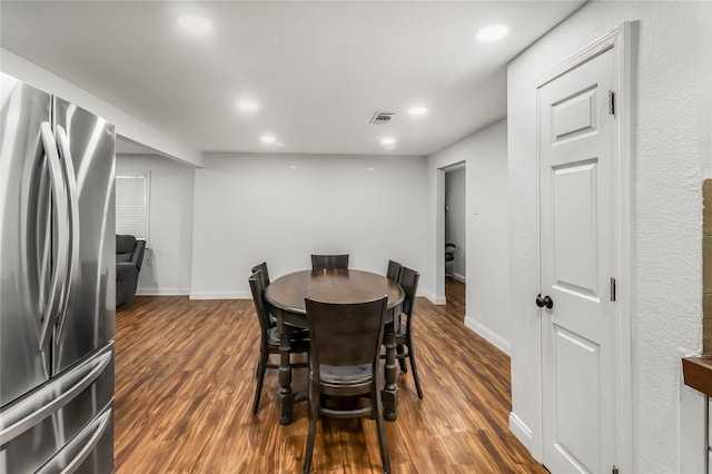 dining space with dark hardwood / wood-style floors