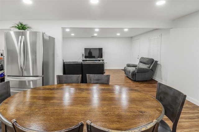 dining space with hardwood / wood-style flooring