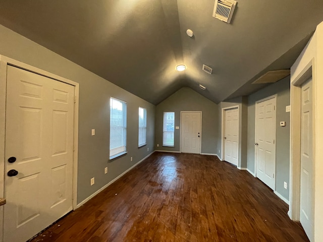 interior space featuring lofted ceiling and dark hardwood / wood-style flooring