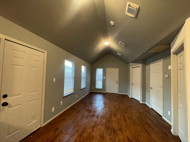 foyer entrance with lofted ceiling and dark hardwood / wood-style floors