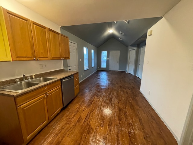 kitchen with dark wood-type flooring, vaulted ceiling, sink, and stainless steel dishwasher