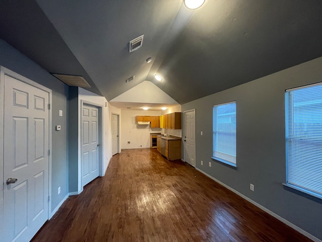 additional living space with dark hardwood / wood-style flooring and lofted ceiling