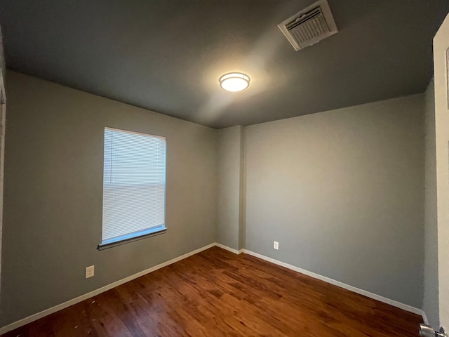 spare room featuring wood-type flooring