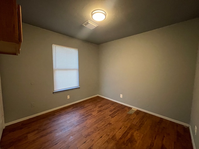 empty room with hardwood / wood-style flooring