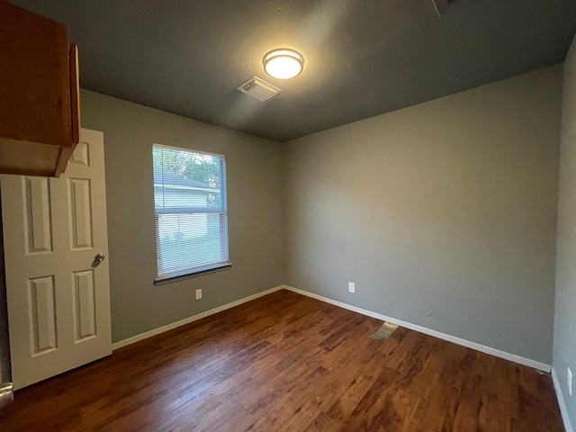 unfurnished room with hardwood / wood-style floors