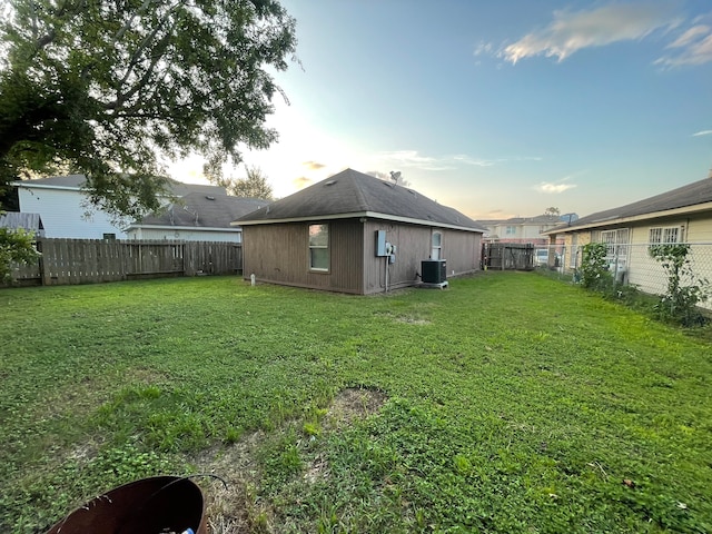 yard at dusk with central AC