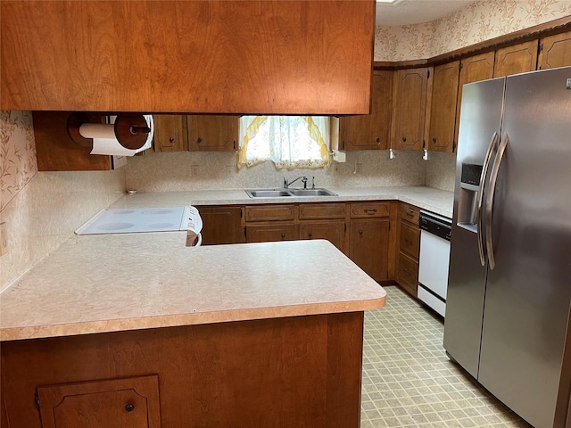1055 County Road 452, Sweeny, TX 77480 - kitchen featuring white appliances, light floors, a peninsula, a sink, and light countertops