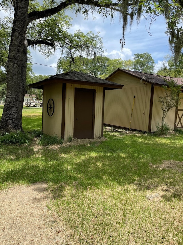 view of outbuilding featuring a lawn