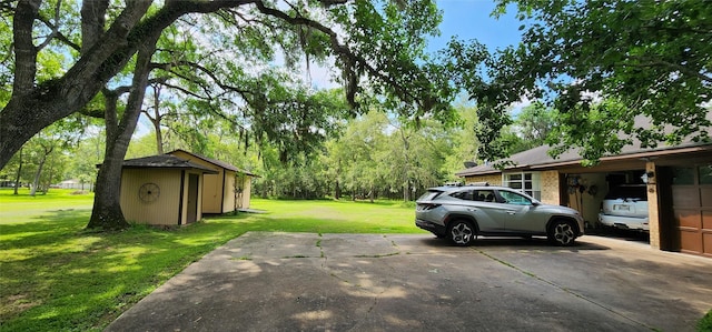 1055 County Road 452, Sweeny, TX 77480 - view of yard with a shed, concrete driveway, and an outdoor structure