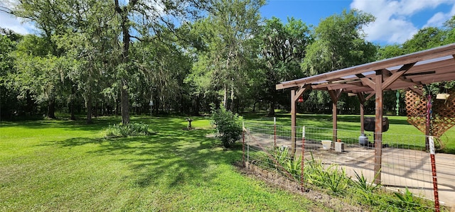 surrounding community featuring a pergola and a lawn