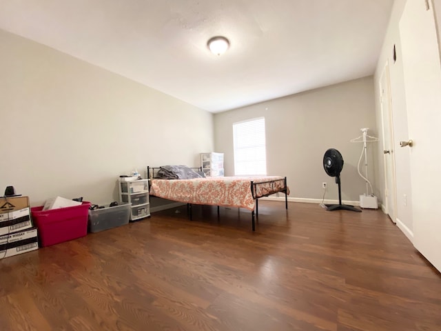 bedroom with dark wood-type flooring