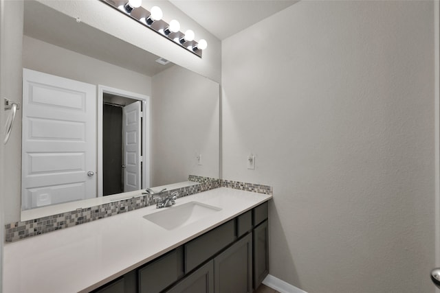 bathroom featuring tasteful backsplash and vanity