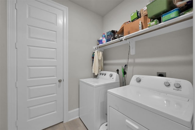 clothes washing area with independent washer and dryer and light hardwood / wood-style floors