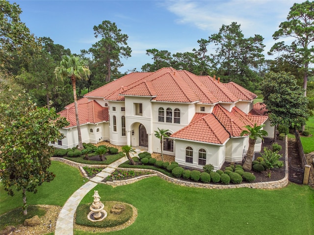 mediterranean / spanish-style home with a front yard