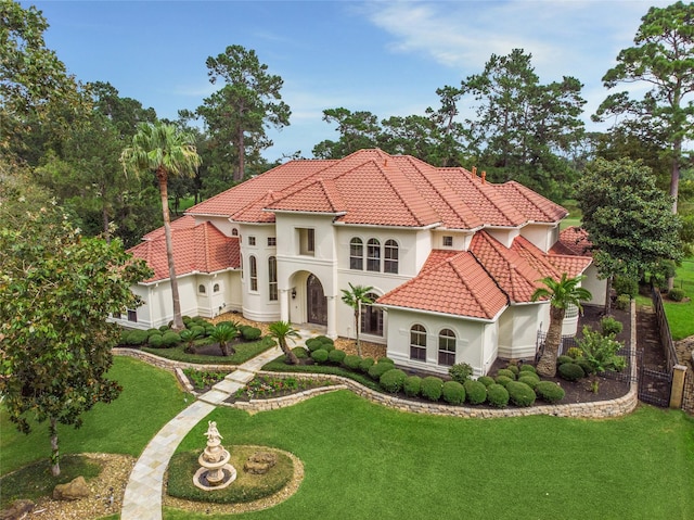 mediterranean / spanish house featuring a front yard